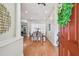 Warm foyer with hardwood floors leading to a dining area bathed in natural light at 1521 Brittany Ct, New Port Richey, FL 34655