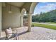 Inviting front porch with stately columns, arched entryways, and brick-paved sitting area at 1521 Brittany Ct, New Port Richey, FL 34655