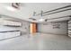 Spacious two car garage with epoxy floor, storage cabinets and utility door at 1521 Brittany Ct, New Port Richey, FL 34655