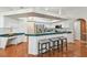 Spacious kitchen with ample counter space, bar seating, modern appliances, and seamless flow into other rooms at 1521 Brittany Ct, New Port Richey, FL 34655