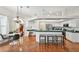Bright, open kitchen featuring barstool seating, modern appliances, ample counter space and seamless flow to dining area at 1521 Brittany Ct, New Port Richey, FL 34655