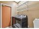 Laundry room featuring modern washer and dryer, utility sink, and wire shelving at 1521 Brittany Ct, New Port Richey, FL 34655