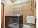 Laundry room featuring modern washer and dryer, utility sink, and wire shelving at 1521 Brittany Ct, New Port Richey, FL 34655