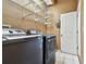 Laundry room featuring modern washer and dryer, utility sink, and wire shelving at 1521 Brittany Ct, New Port Richey, FL 34655