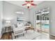 Cozy living room with sliding door to screened-in pool area with modern furniture and decor at 1521 Brittany Ct, New Port Richey, FL 34655