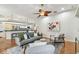 Bright living room with hardwood floors, modern furniture, and an open view to the kitchen at 1521 Brittany Ct, New Port Richey, FL 34655
