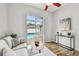 Bright living room featuring wood floors and slider doors leading to the backyard pool at 1521 Brittany Ct, New Port Richey, FL 34655