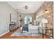 Relaxing main bedroom with exposed brick wall, ceiling fan, and seating area at 1521 Brittany Ct, New Port Richey, FL 34655