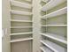Spacious pantry features white shelving for plenty of storage at 1521 Brittany Ct, New Port Richey, FL 34655
