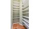 Walk-in pantry features wood floors and white shelving at 1521 Brittany Ct, New Port Richey, FL 34655