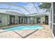 Beautiful screened-in pool area with brick patio, offering the perfect outdoor entertainment space at 1521 Brittany Ct, New Port Richey, FL 34655