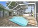 Screened in outdoor pool and lanai area with brick pavers and mature trees at 1521 Brittany Ct, New Port Richey, FL 34655