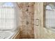 Walk-in shower featuring neutral tile surround, window, and glass doors at 1521 Brittany Ct, New Port Richey, FL 34655