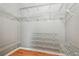 Large walk-in closet with wire shelving and ample storage for all your clothing at 1521 Brittany Ct, New Port Richey, FL 34655