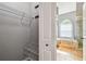Walk-in closet with door open to bathroom, and wire shelving for storage and organization at 1521 Brittany Ct, New Port Richey, FL 34655
