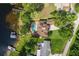 Bird's eye view of waterfront property, pool, lush yard, and long driveway at 1834 Daiquiri Ln, Lutz, FL 33549