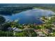 Expansive view of lake and home; waterfront docks and lush green landscape at 1834 Daiquiri Ln, Lutz, FL 33549