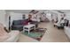Spacious bedroom featuring a gray couch, white coffee table, and a unique Marvel-themed rug at 1834 Daiquiri Ln, Lutz, FL 33549