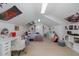 Bright bedroom showcasing a white desk, chair, and decor with a cozy bed and a skylight at 1834 Daiquiri Ln, Lutz, FL 33549