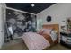 Stylish bedroom featuring a modern black and white wallpaper, a rattan bed frame, and a dark ceiling at 1834 Daiquiri Ln, Lutz, FL 33549