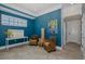 Bonus room offering blue walls, decor, seating, and an adjacent doorway at 1834 Daiquiri Ln, Lutz, FL 33549