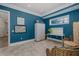 Bonus room boasting bright blue walls, a window, stylish decor, and comfortable seating at 1834 Daiquiri Ln, Lutz, FL 33549