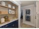 Hallway butler's pantry featuring blue cabinets, marble countertops, and decor at 1834 Daiquiri Ln, Lutz, FL 33549