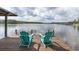 Relax on this dock featuring two inviting Adirondack chairs and scenic water views at 1834 Daiquiri Ln, Lutz, FL 33549