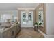 Inviting foyer featuring wood flooring, modern decor, and bright natural lighting at 1834 Daiquiri Ln, Lutz, FL 33549