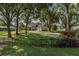 Charming home with manicured lawn, mature trees, and a circular driveway at 1834 Daiquiri Ln, Lutz, FL 33549