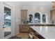 Bright kitchen with a tile backsplash, breakfast bar, and views of the pool and waterway at 1834 Daiquiri Ln, Lutz, FL 33549