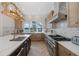 Spacious kitchen boasts stainless steel appliances, a tile backsplash, and a beautiful waterfront view at 1834 Daiquiri Ln, Lutz, FL 33549