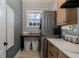 Laundry room with gray wallpaper, a window, and washer and dryer at 1834 Daiquiri Ln, Lutz, FL 33549