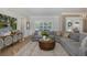 Inviting living room with a large sectional, decorative cabinet, and modern decor at 1834 Daiquiri Ln, Lutz, FL 33549