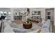 Open-concept living room with wood floors, staircase, and views into the kitchen at 1834 Daiquiri Ln, Lutz, FL 33549