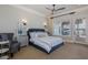 Calming bedroom with a ceiling fan, accent chair, and sliding doors leading to the outdoor area at 1834 Daiquiri Ln, Lutz, FL 33549