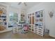 Inviting home office boasts custom built-ins, a window seat, and views of the tranquil lake at 1834 Daiquiri Ln, Lutz, FL 33549