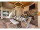 Elegant outdoor dining area with a stone fireplace and a beautifully set table, perfect for entertaining at 1834 Daiquiri Ln, Lutz, FL 33549