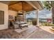 Stylish outdoor dining area with a stone fireplace, TV, and picturesque lake views at 1834 Daiquiri Ln, Lutz, FL 33549