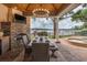 Outdoor dining area featuring a stone fireplace, chandelier, and a view of the lake at 1834 Daiquiri Ln, Lutz, FL 33549