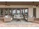 Covered brick patio features comfortable seating, ceiling fans, and picturesque lake views at 1834 Daiquiri Ln, Lutz, FL 33549