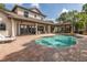 Beautiful outdoor pool area with a brick patio and a covered seating area at 1834 Daiquiri Ln, Lutz, FL 33549
