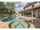 Backyard pool and spa with outdoor seating area and a view of a beautiful lake at 1834 Daiquiri Ln, Lutz, FL 33549