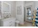 Charming powder room with decorative wallpaper, stylish mirror, and access to outdoor shower at 1834 Daiquiri Ln, Lutz, FL 33549