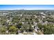 An aerial view of the area shows residential homes with lush trees and the city skyline in the distance at 212 W Powhatan Ave, Tampa, FL 33604