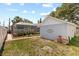 A backyard featuring a well-maintained lawn, garage and screened pool area at 212 W Powhatan Ave, Tampa, FL 33604