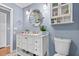 Updated bathroom with a modern vanity, round mirror, and decorative wall sconces at 212 W Powhatan Ave, Tampa, FL 33604