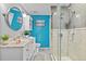 Charming bathroom features modern vanity, stylish mirror, and tiled walk-in shower at 212 W Powhatan Ave, Tampa, FL 33604