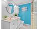 Bright bathroom features modern vanity, stylish mirror, and tiled walk-in shower at 212 W Powhatan Ave, Tampa, FL 33604