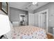 Comfortable bedroom with a ceiling fan, closet, and doorway leading to the kitchen at 212 W Powhatan Ave, Tampa, FL 33604